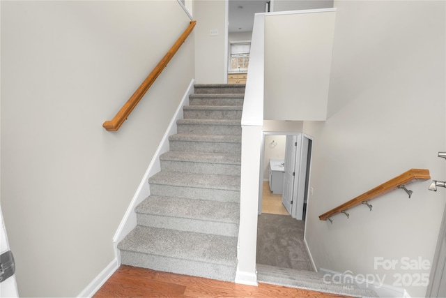 stairs featuring baseboards and wood finished floors