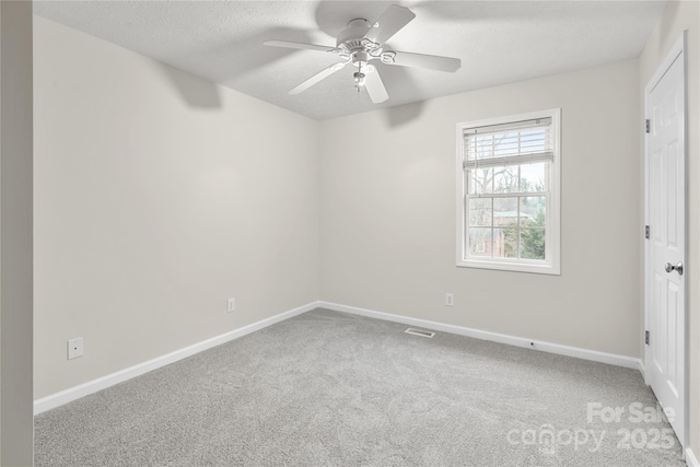 unfurnished bedroom with visible vents, baseboards, carpet floors, a textured ceiling, and a ceiling fan