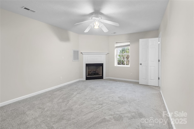 unfurnished living room with visible vents, baseboards, carpet, and a fireplace