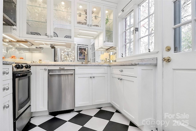 1817 Jameston Dr, Charlotte, NC 28209 - kitchen with glass insert cabinets, light floors, appliances with stainless steel finishes, and white cabinetry