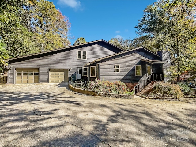 view of side of property with a garage and driveway