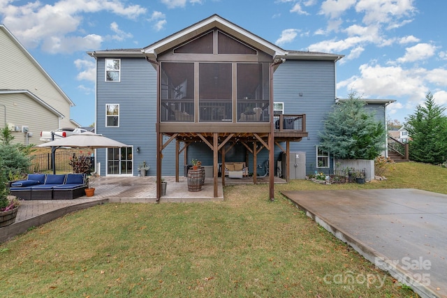 back of house with an outdoor living space, a lawn, a patio, and a sunroom