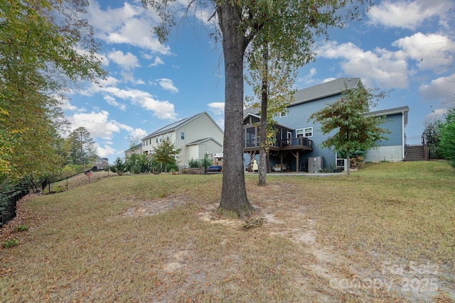 view of yard with a deck and fence