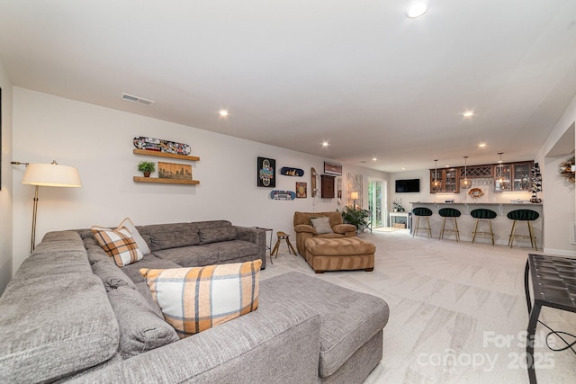 living area featuring a dry bar, recessed lighting, visible vents, and light carpet