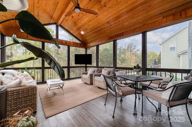 sunroom / solarium with ceiling fan, wooden ceiling, and vaulted ceiling