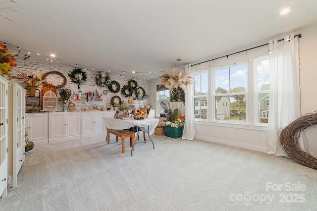 unfurnished dining area featuring recessed lighting, track lighting, light colored carpet, and visible vents