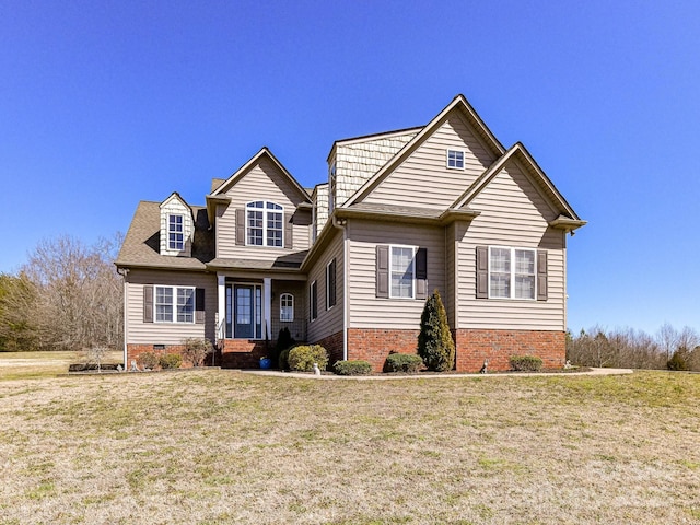 view of front facade featuring crawl space, brick siding, and a front yard