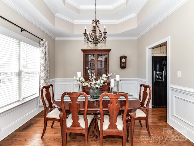816 Springs Rd, Dallas, NC 28034 - dining area featuring a chandelier, a tray ceiling, dark wood-type flooring, wainscoting, and ornamental molding