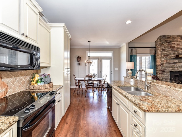 816 Springs Rd, Dallas, NC 28034 - kitchen featuring a sink, black appliances, decorative backsplash, dark wood finished floors, and a stone fireplace