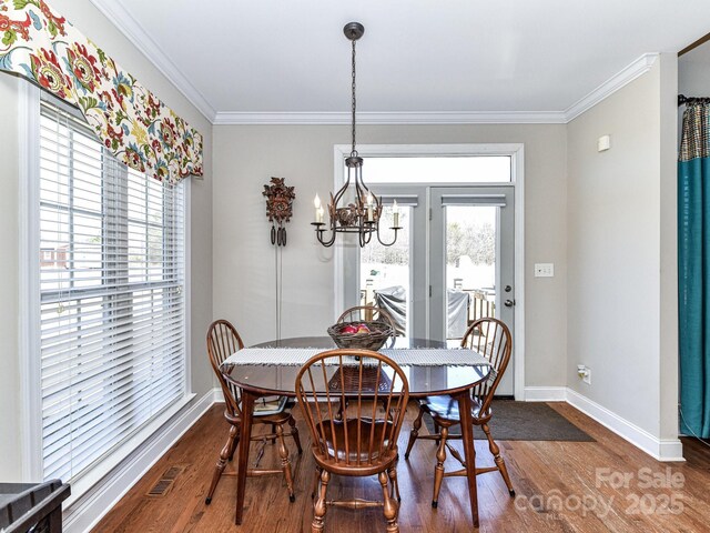 816 Springs Rd, Dallas, NC 28034 - dining room featuring dark wood finished floors, a chandelier, and ornamental molding