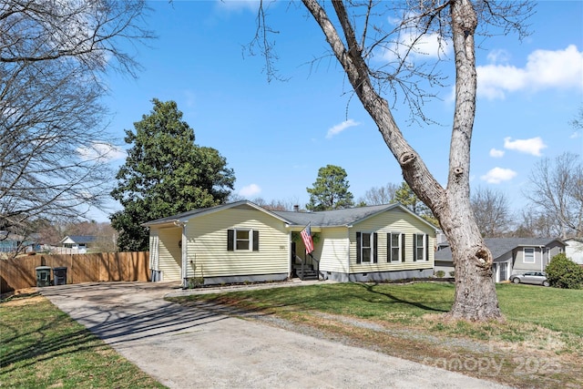 view of front facade with crawl space, driveway, a front lawn, and fence