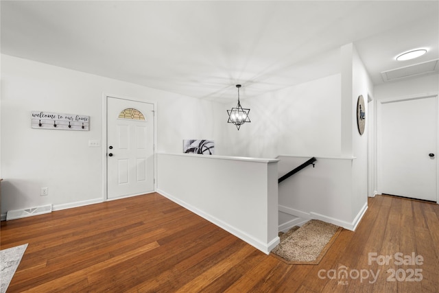 entrance foyer featuring visible vents, baseboards, and hardwood / wood-style floors