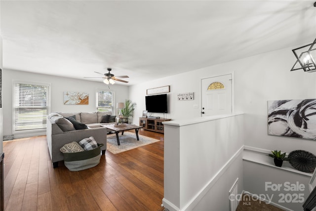 living room featuring ceiling fan and dark wood-style flooring