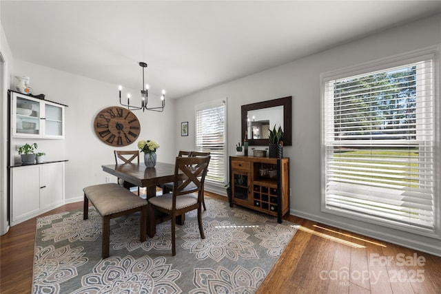 dining room featuring a chandelier and wood finished floors