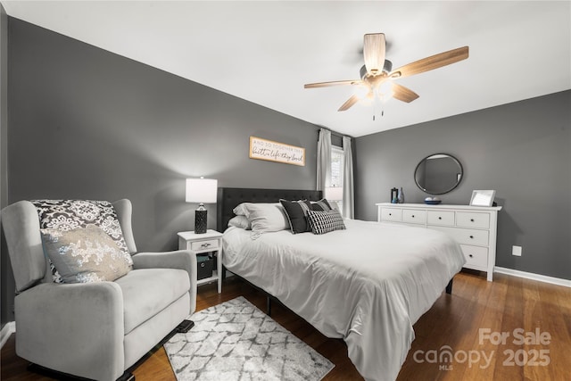 bedroom with dark wood-style floors, baseboards, and ceiling fan