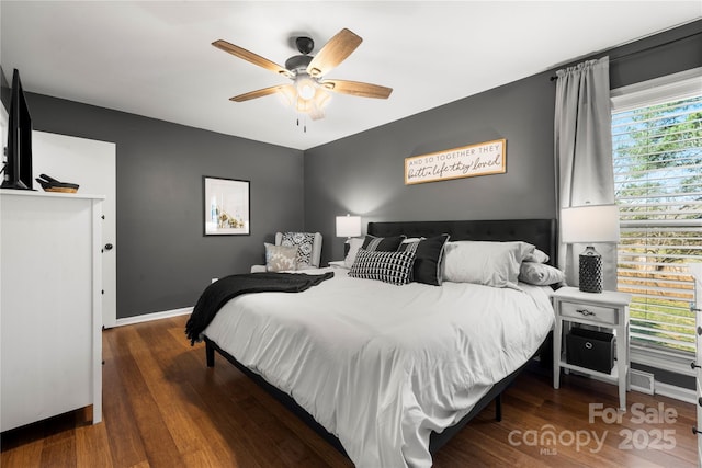 bedroom featuring ceiling fan, baseboards, and wood finished floors