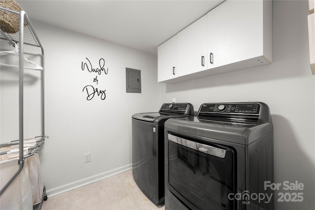 clothes washing area featuring electric panel, baseboards, cabinet space, and washer and clothes dryer