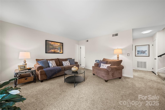 living room featuring visible vents, carpet flooring, and baseboards