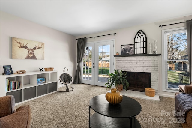 living room featuring french doors, carpet floors, baseboards, and a fireplace