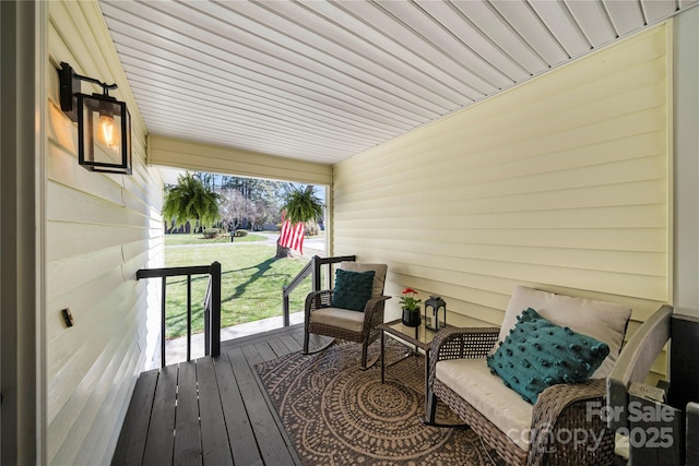 deck with covered porch and a lawn