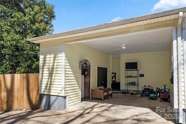 exterior space with a carport and fence