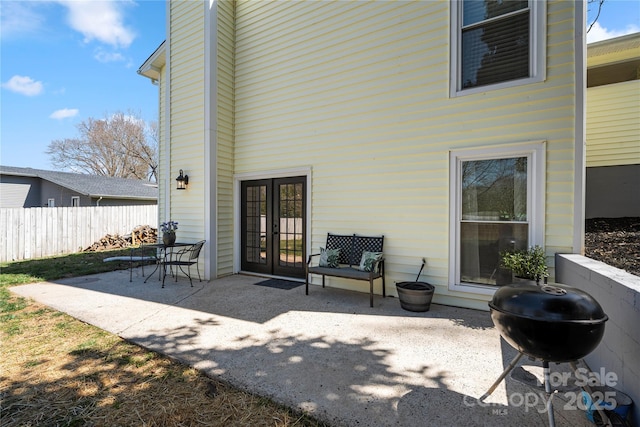 view of patio featuring area for grilling, french doors, and fence