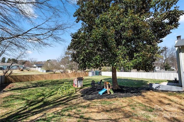 view of yard featuring an outbuilding, a storage shed, and a fenced backyard