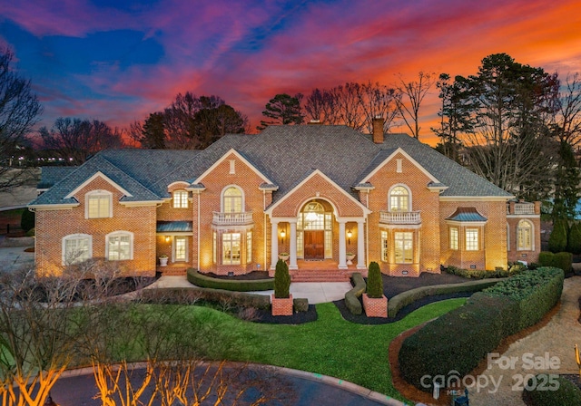 colonial home with crawl space, brick siding, and a chimney