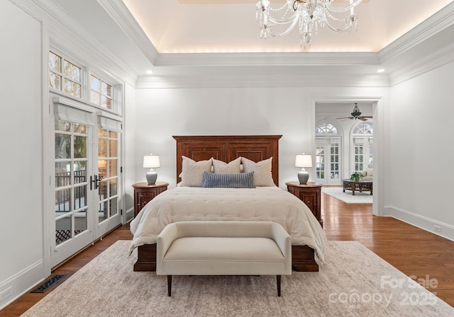 bedroom with wood finished floors, french doors, an inviting chandelier, baseboards, and access to exterior