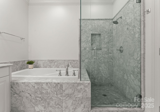 full bathroom featuring vanity, a garden tub, ornamental molding, and a shower stall