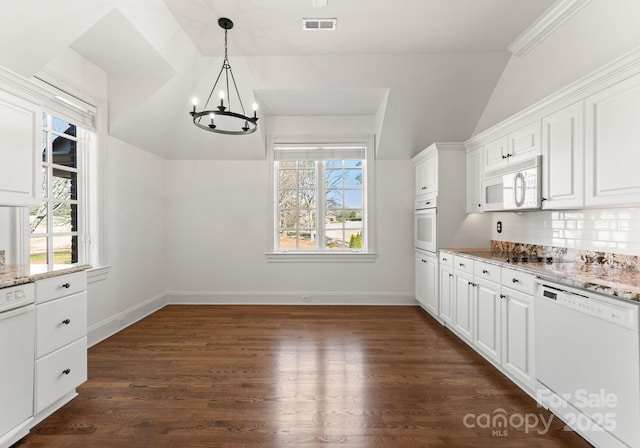 kitchen featuring white appliances, light stone countertops, dark wood finished floors, vaulted ceiling, and white cabinets