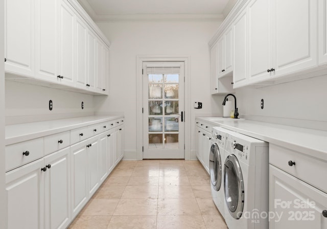 laundry area with a sink, cabinet space, separate washer and dryer, and crown molding