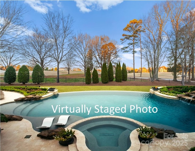 view of pool featuring fence