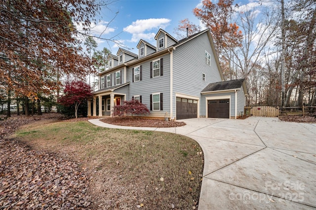 view of side of property with a yard, concrete driveway, and fence