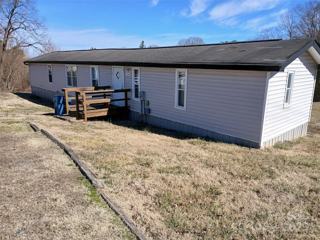 back of house featuring a yard and a wooden deck