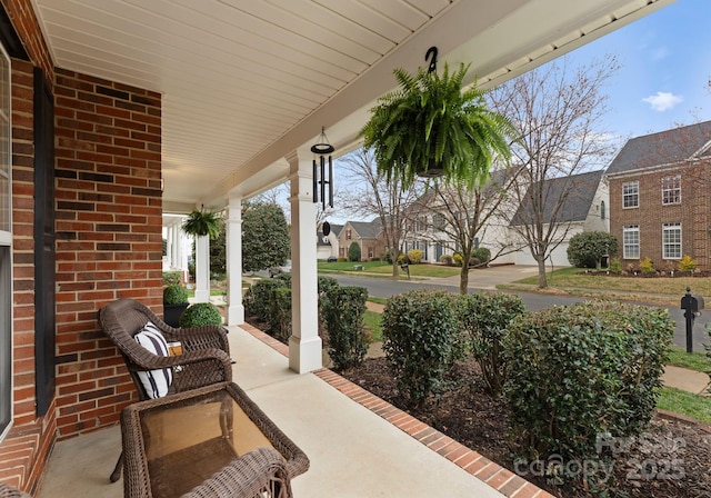 view of patio / terrace with a residential view and a porch