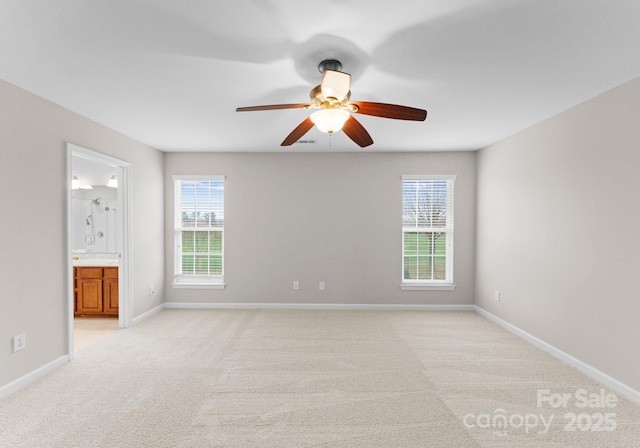 unfurnished room with baseboards, light carpet, and a ceiling fan