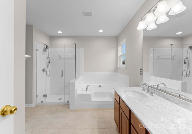 full bathroom with visible vents, a garden tub, a shower stall, and vanity