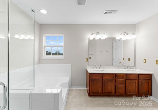 bathroom with a bath, visible vents, and a sink