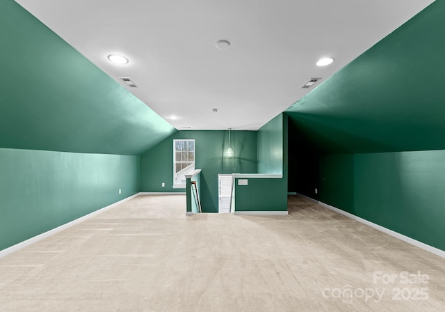 bonus room featuring visible vents, baseboards, carpet floors, and vaulted ceiling