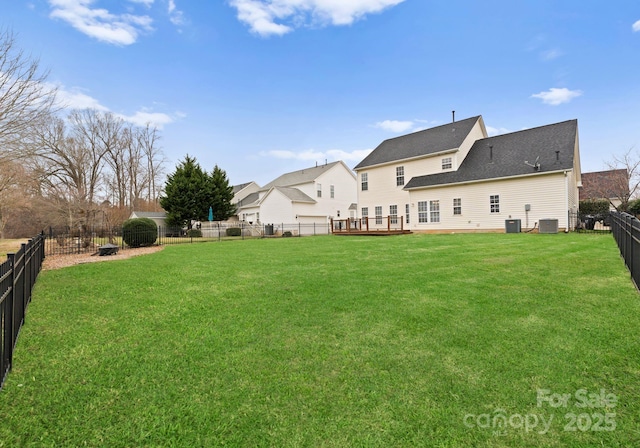 view of yard featuring cooling unit, a deck, and a fenced backyard