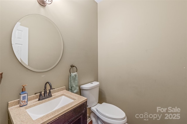 bathroom featuring toilet and vanity