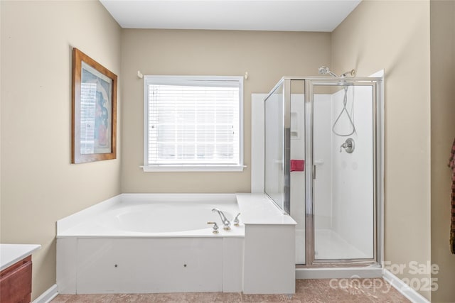 bathroom featuring a garden tub and a stall shower