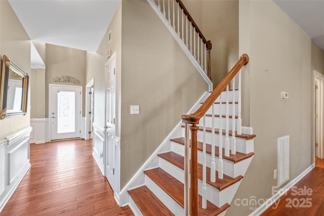 stairs featuring visible vents and wood-type flooring