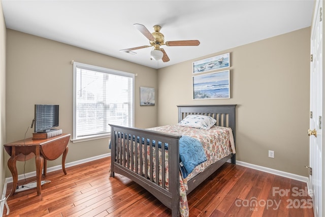 bedroom with visible vents, baseboards, wood finished floors, and a ceiling fan