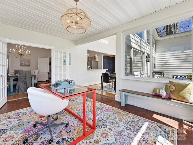 office with baseboards and a notable chandelier