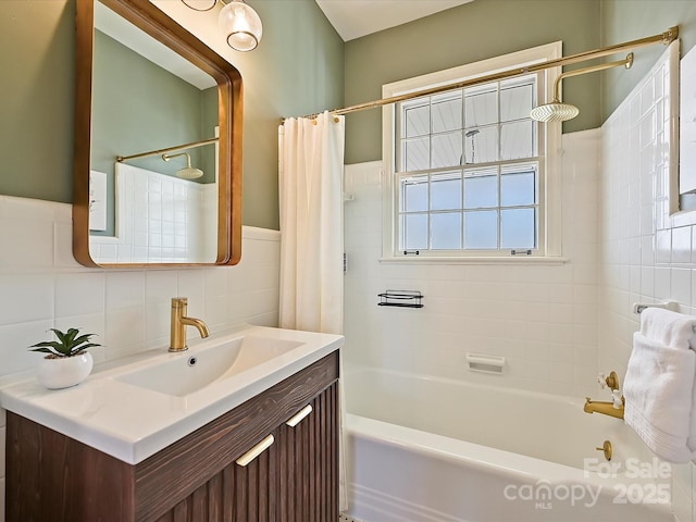 bathroom with vanity, tile walls, and shower / tub combo