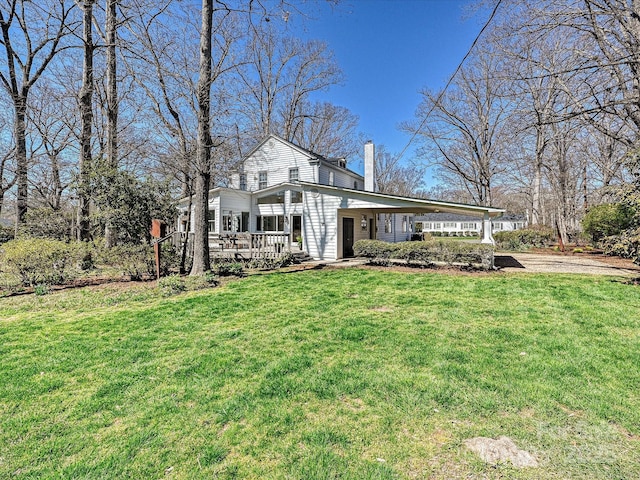 view of front of house with a front lawn and a chimney