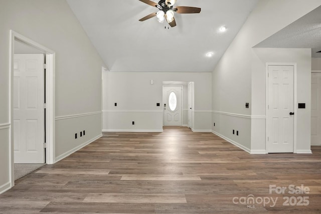 entryway with vaulted ceiling, baseboards, ceiling fan, and wood finished floors