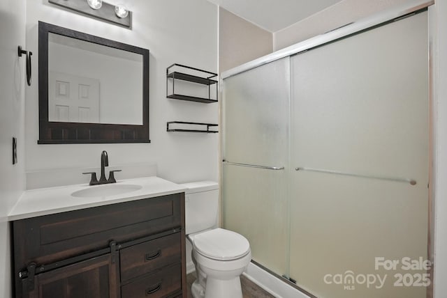 full bath with a shower stall, toilet, and vanity